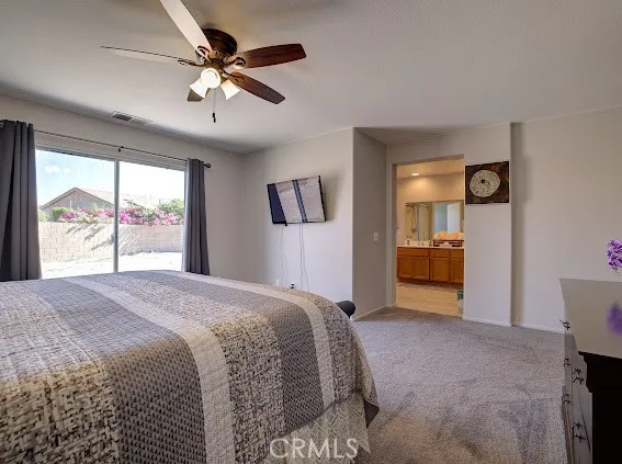 a spacious bedroom with a bed and a large window