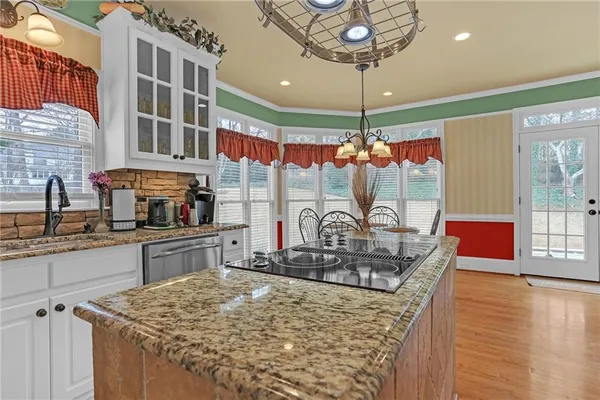 a kitchen with stainless steel appliances granite countertop a stove and cabinets
