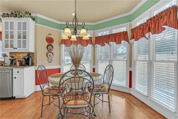 a view of a dining room with furniture window and wooden floor