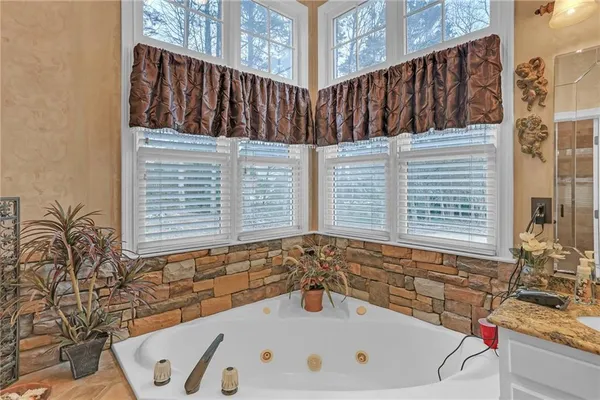 a spacious bathroom with double vanity and a chandelier