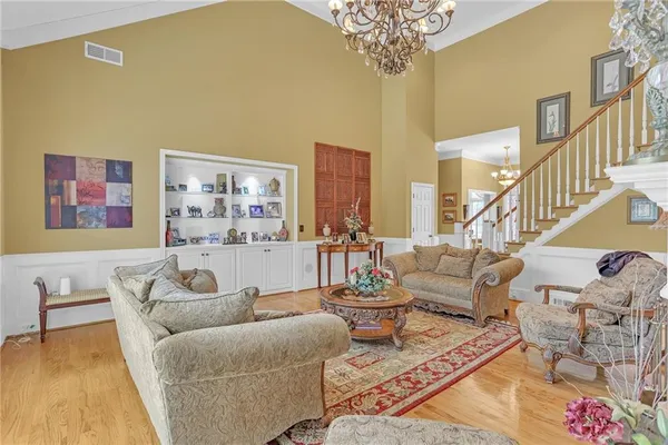 a living room with furniture and a chandelier