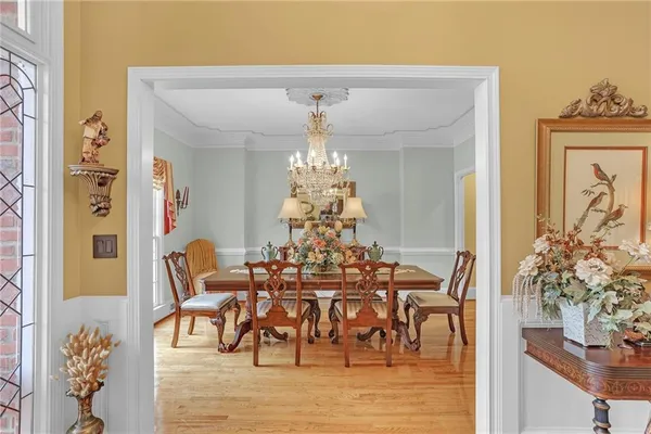 a view of a dining room with furniture and chandelier