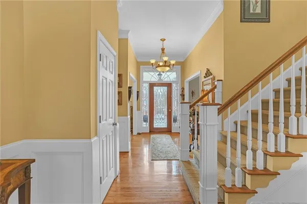 a view of entryway and hall with wooden floor