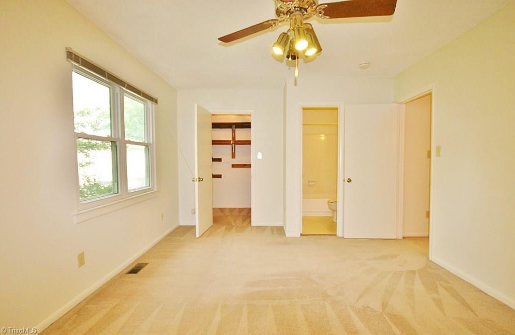 5725 Bramblegate Road, Unit A Greensboro, NC 27409 - Photo 13 of 28 Master Bedroom facing the walk-in closet & full bathroom (with doors open)...