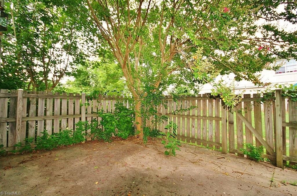 5725 Bramblegate Road, Unit A Greensboro, NC 27409 - Photo 18 of 28 Huge back Patio with Privacy Fence to enjoy gatherings with family or friends!