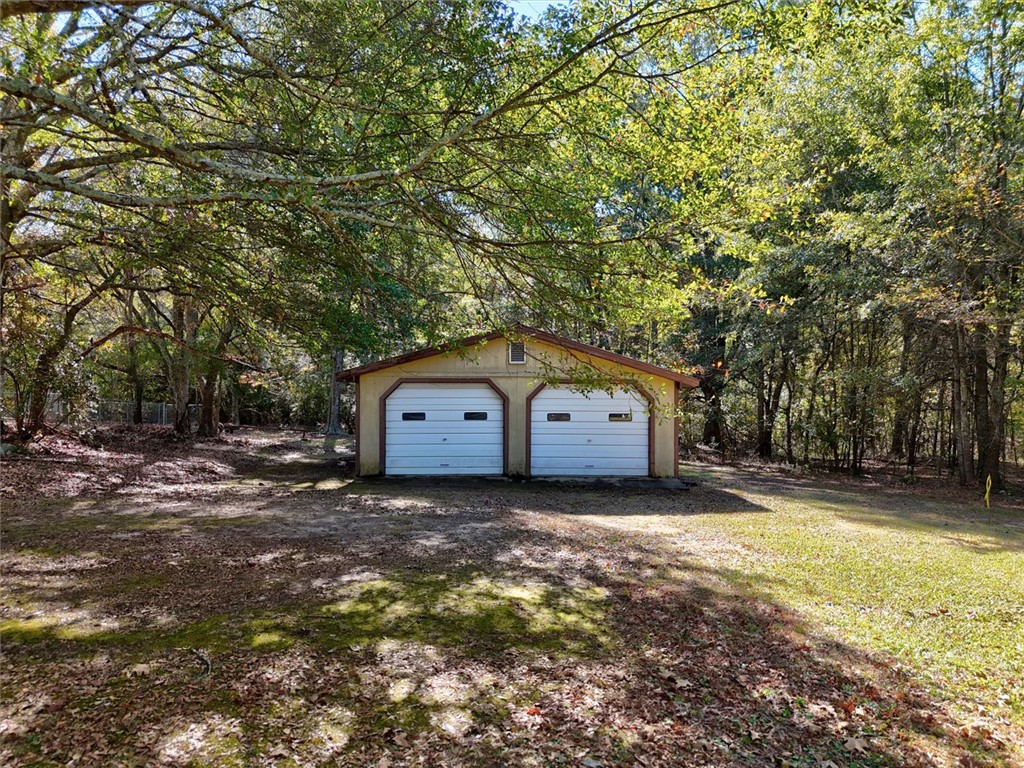 0 Cromer Road, Unit 245 CROMER ROAD Williamston, SC 29697 - Photo 12 of 24 This secluded garage offers ample space for vehicles and storage amidst natural surroundings.