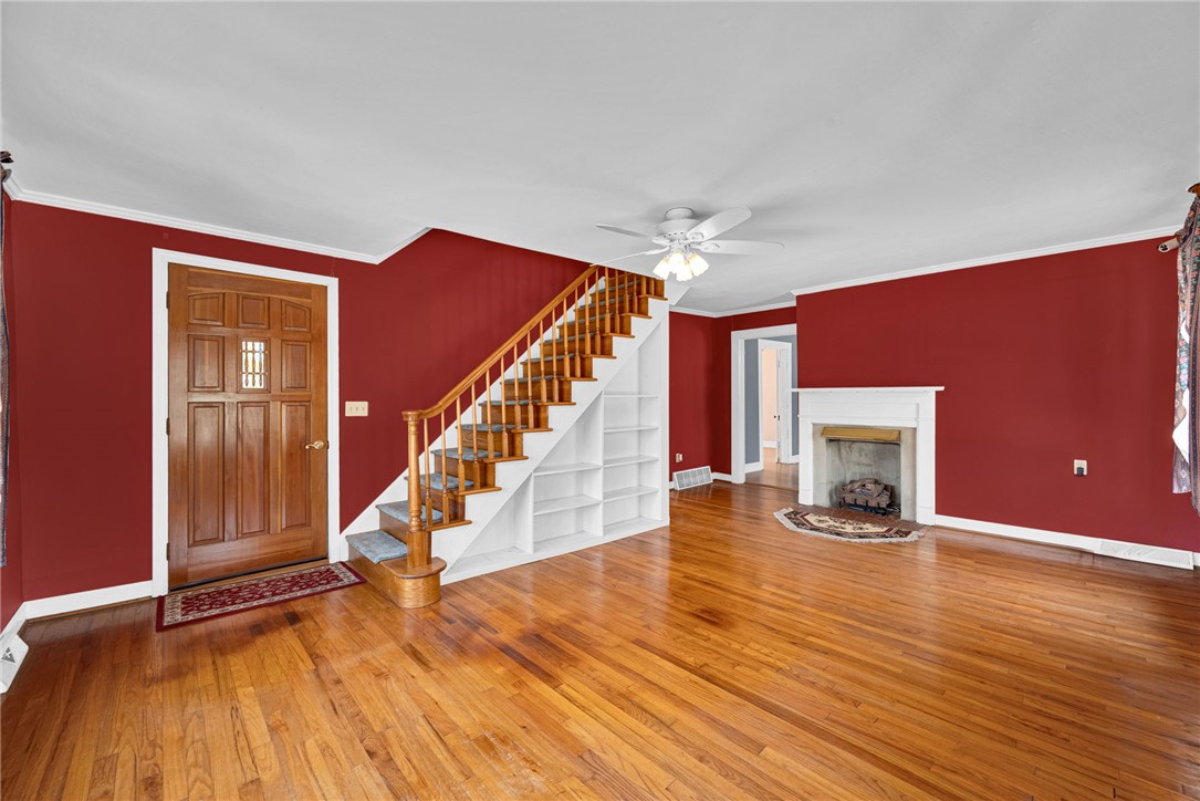 0 Cromer Road, Unit 245 CROMER ROAD Williamston, SC 29697 - Photo 17 of 24 This inviting space features hardwood floors, a prominent fireplace, and a striking staircase with built-in shelving.