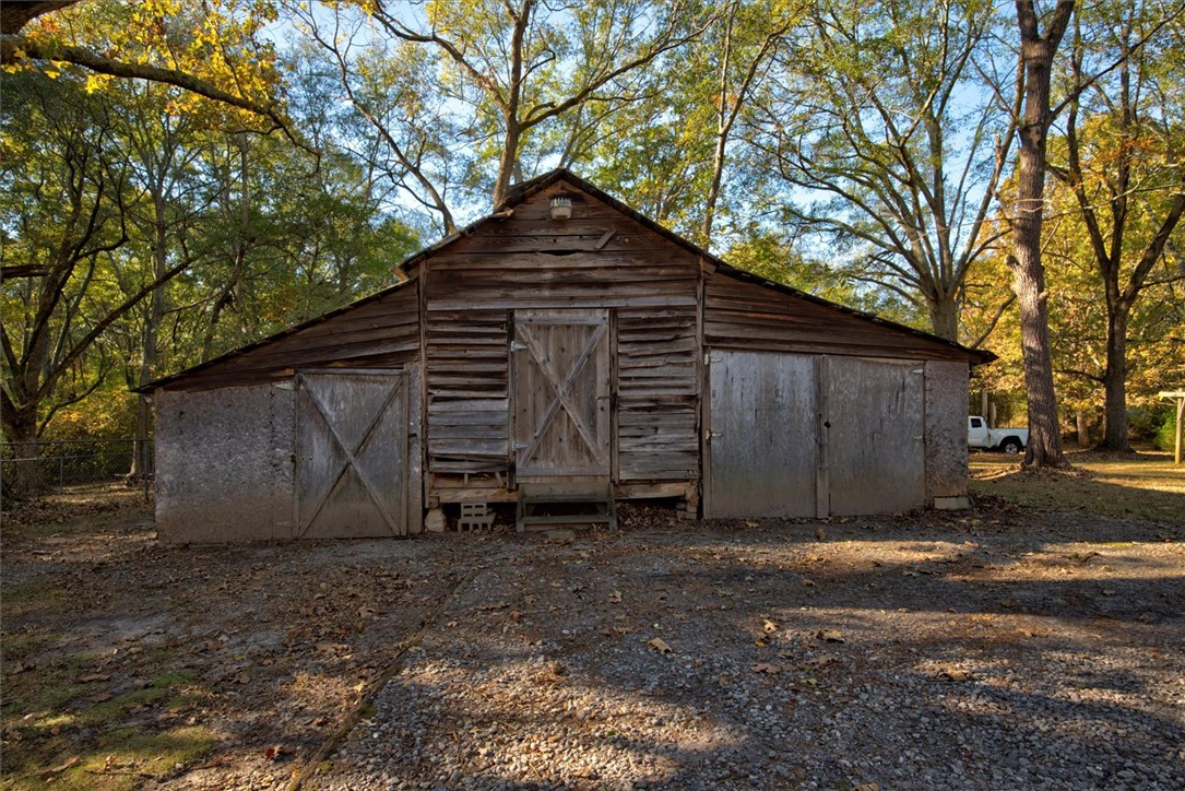 0 Cromer Road, Unit 245 CROMER ROAD Williamston, SC 29697 - Photo 10 of 24 This rustic barn offers ample storage and a touch of rural charm amidst a wooded landscape.