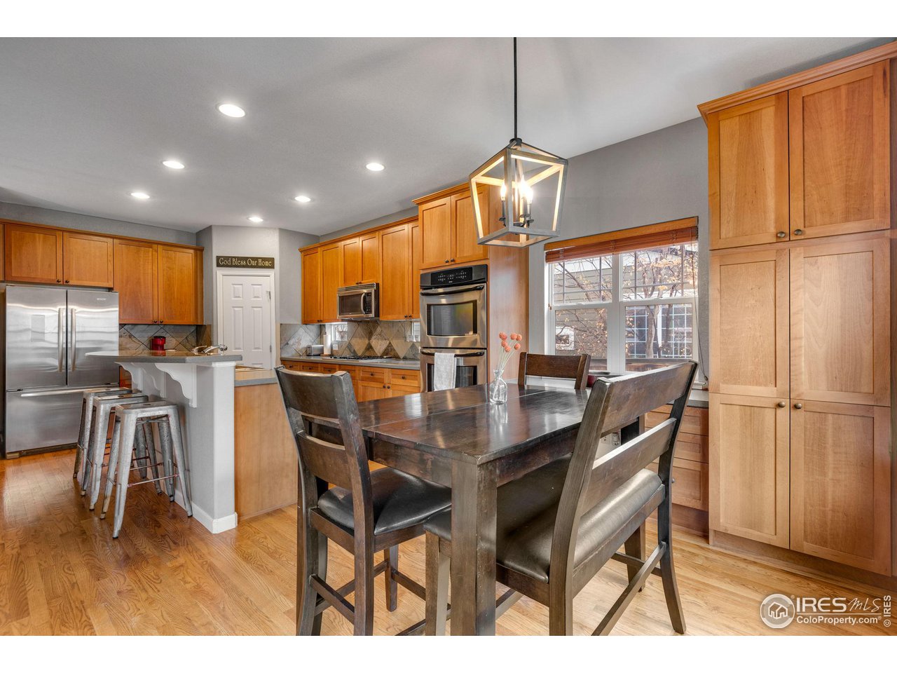 4115 Frederick Circle Longmont, CO 80503 - Photo 17 of 39 a dining room with stainless steel appliances kitchen island granite countertop a dining table chairs and granite counter tops