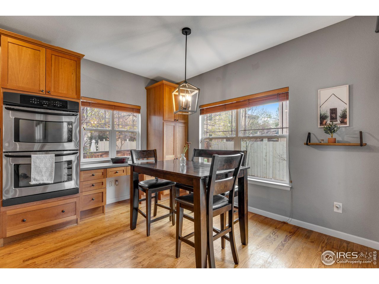 4115 Frederick Circle Longmont, CO 80503 - Photo 18 of 39 a dining room with furniture a floor to ceiling window and wooden floor