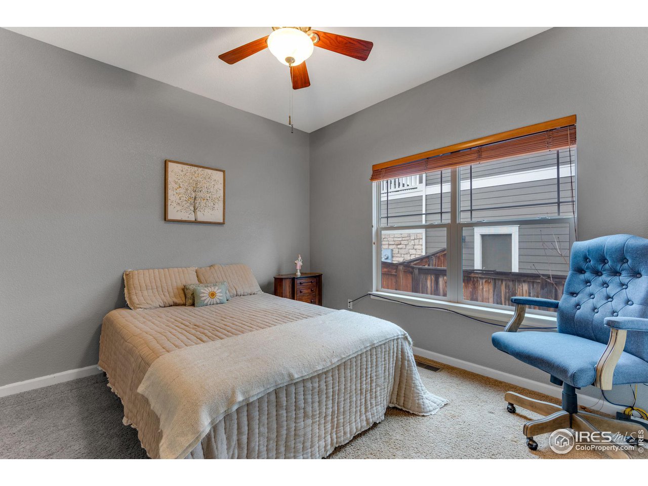 4115 Frederick Circle Longmont, CO 80503 - Photo 19 of 39 a bedroom with a bed and a chandelier