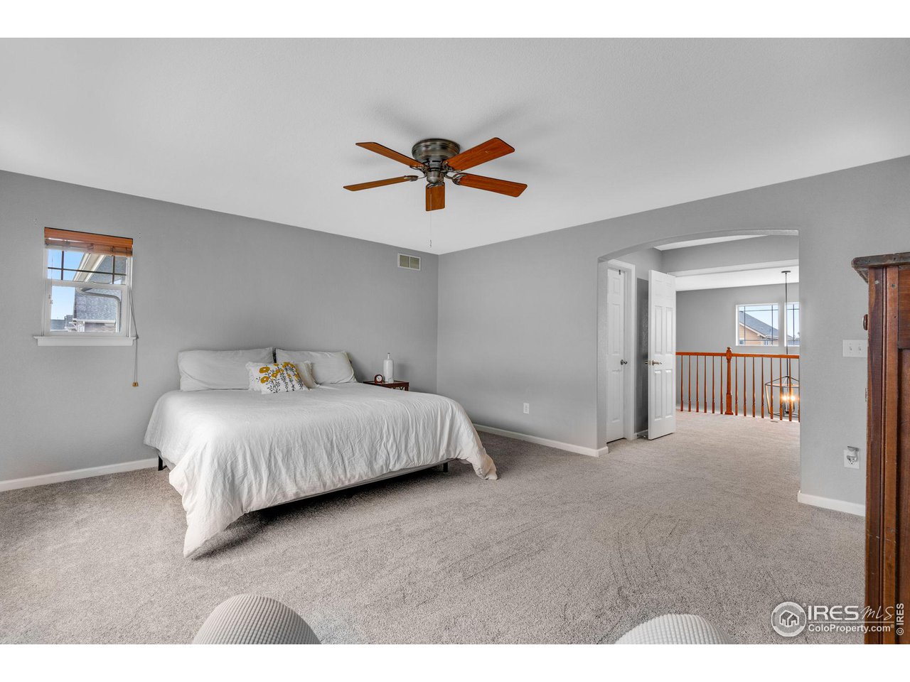4115 Frederick Circle Longmont, CO 80503 - Photo 24 of 39 a bedroom with a bed and glass walk in closet