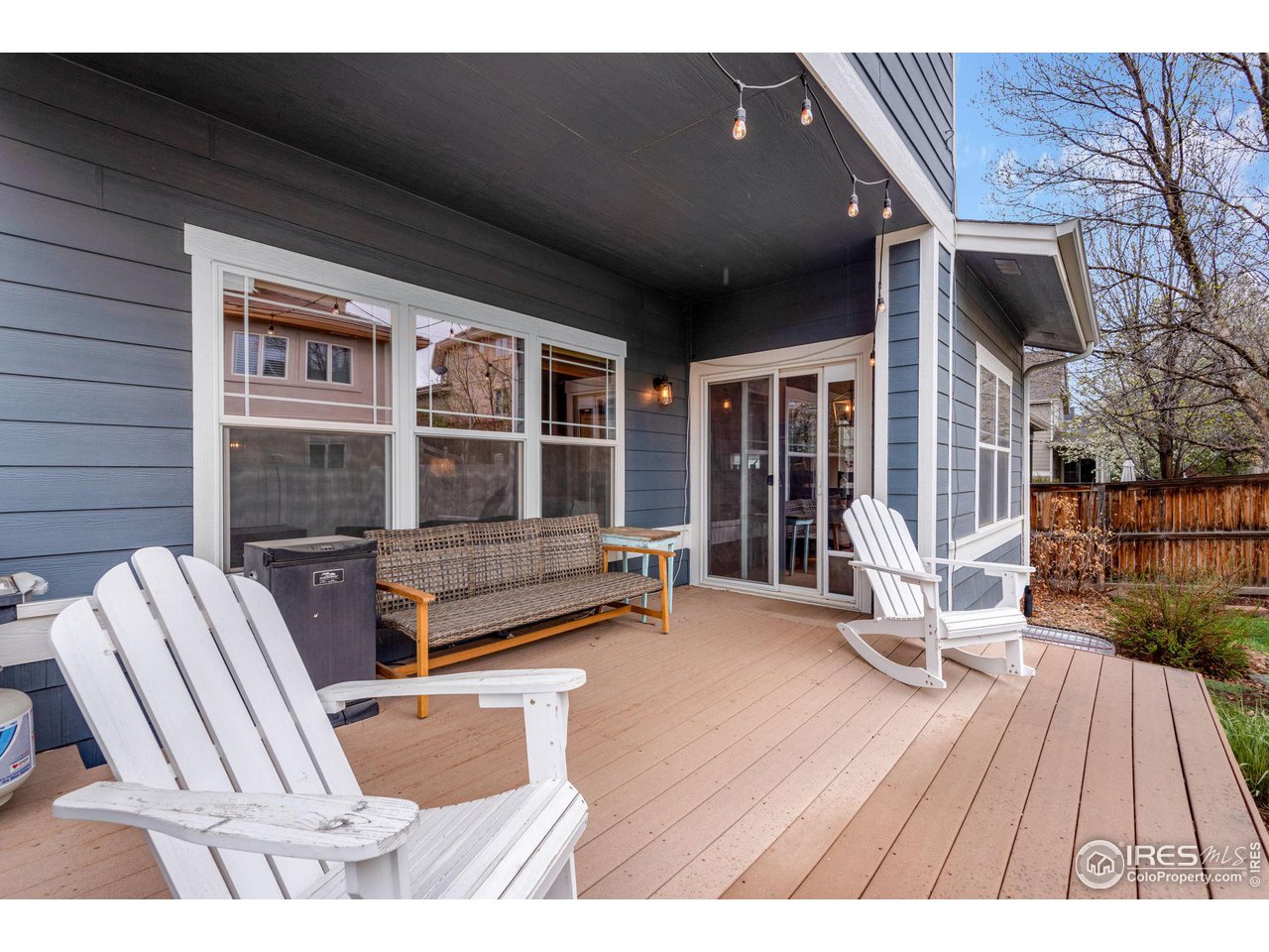 4115 Frederick Circle Longmont, CO 80503 - Photo 34 of 39 a balcony with furniture and wooden floor
