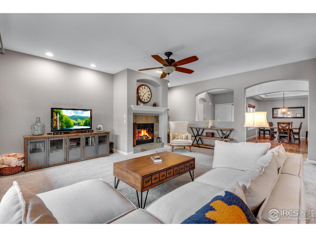 4115 Frederick Circle Longmont, CO 80503 - Photo 9 of 39 a living room with furniture a flat screen tv and a fireplace
