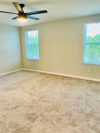 a view of a livingroom with a ceiling fan and window
