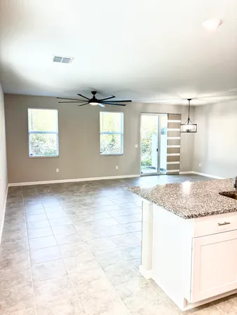 a view of a livingroom with furniture and an empty room