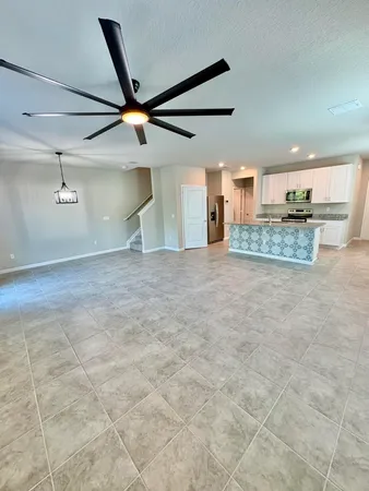 a kitchen with stainless steel appliances granite countertop a refrigerator a stove and a sink