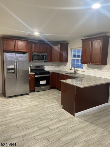 455 South 14th Street, Unit 3 Newark, NJ 07103 - Photo 2 of 10 a kitchen with stainless steel appliances granite countertop a refrigerator and a stove top oven
