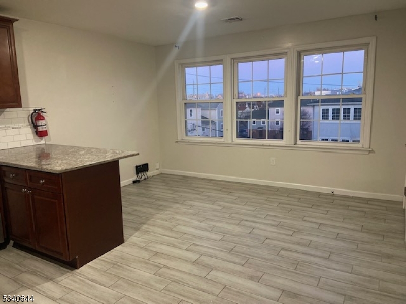 455 South 14th Street, Unit 3 Newark, NJ 07103 - Photo 6 of 10 a bathroom with a granite countertop sink and a mirror