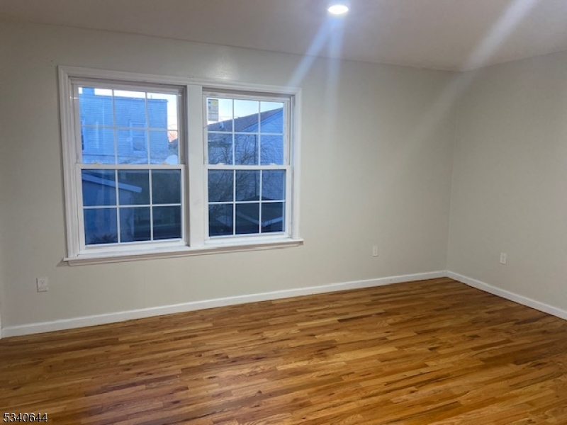 455 South 14th Street, Unit 3 Newark, NJ 07103 - Photo 8 of 10 a view of empty room with wooden floor and windows