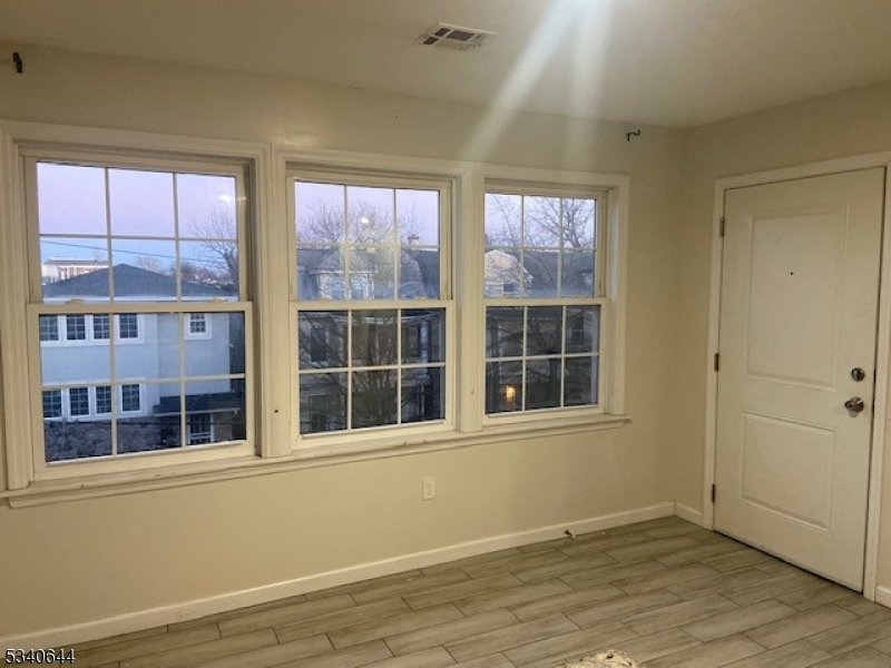 455 South 14th Street, Unit 3 Newark, NJ 07103 - Photo 10 of 10 an empty room with wooden floor and windows