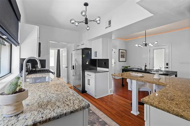 a large kitchen with kitchen island a sink stainless steel appliances and cabinets