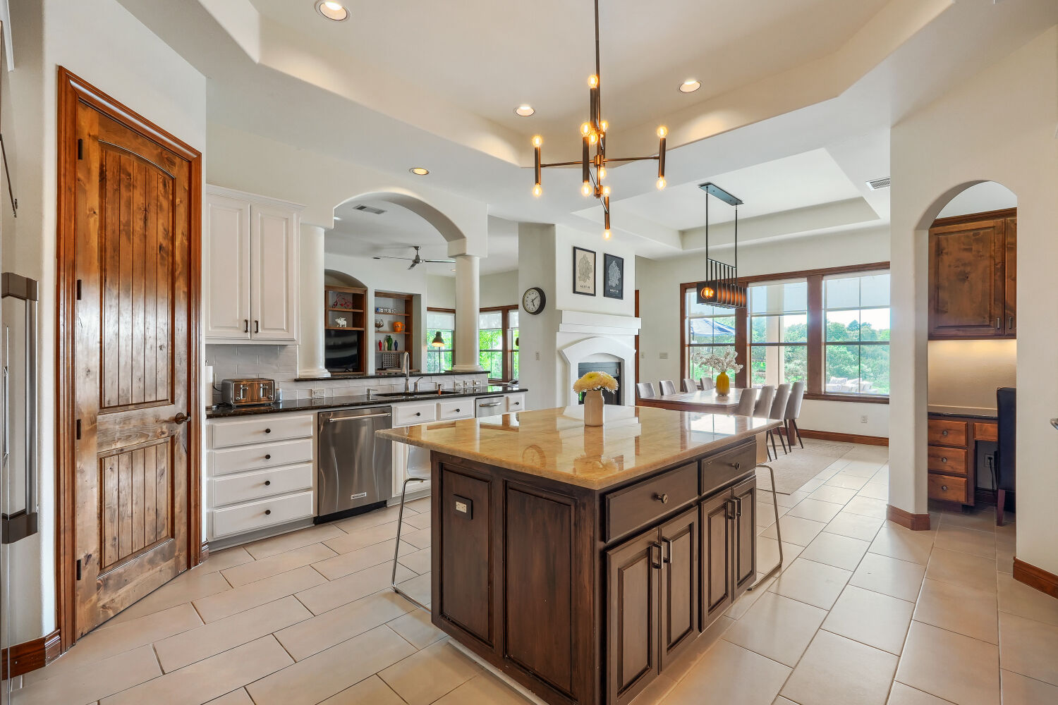 701 Hurst Creek Road Lakeway, TX 78734 - Photo 10 of 37 Open-concept kitchen with a central island featuring a granite updated paint on cabinets, updated fixture, large pantry, and stainless steel appliances. Small secondary office/desk space in kitchen