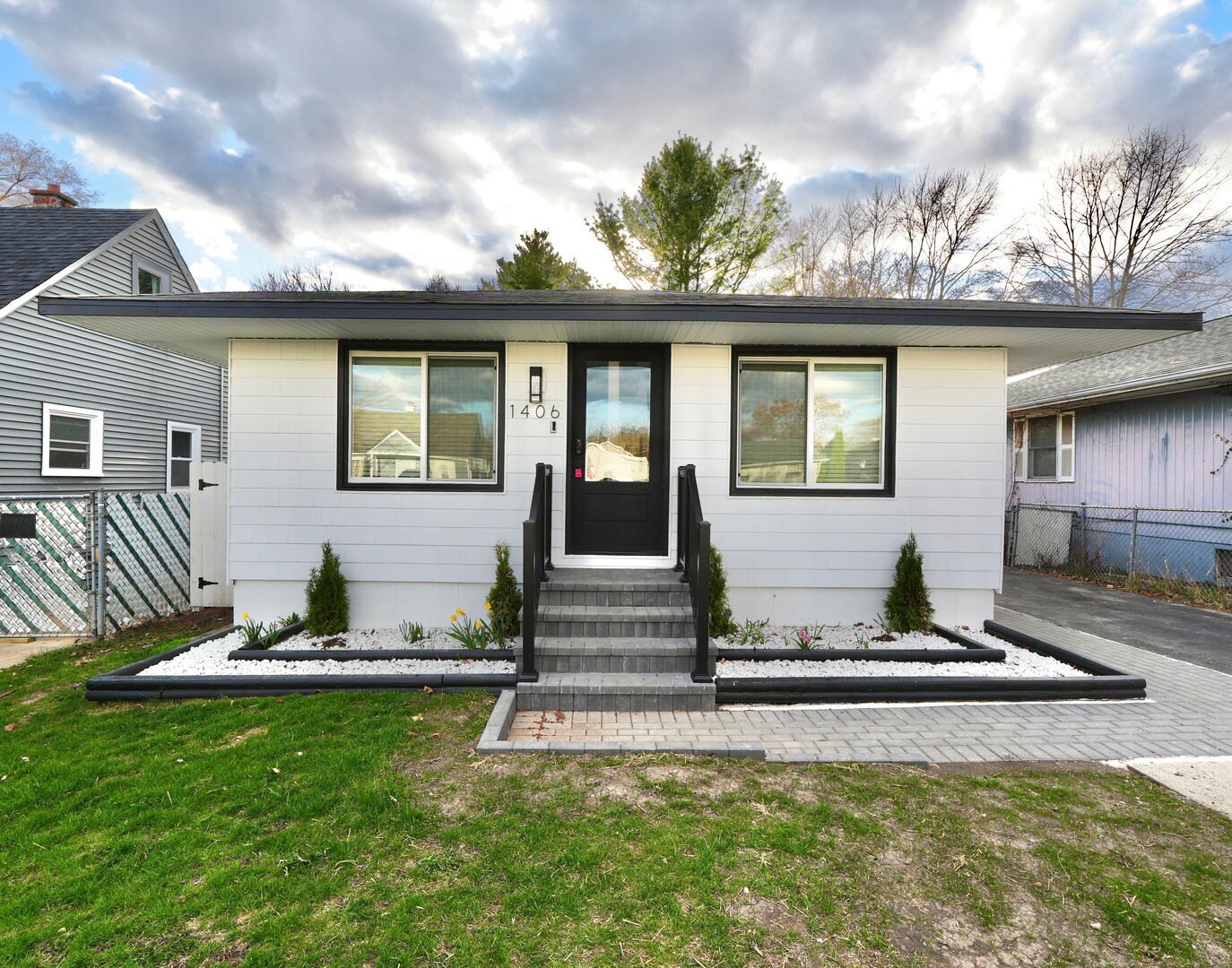 1406 Ridgeway Street Round Lake Beach, IL 60073 - Photo 1 of 33 a front view of a house with a yard