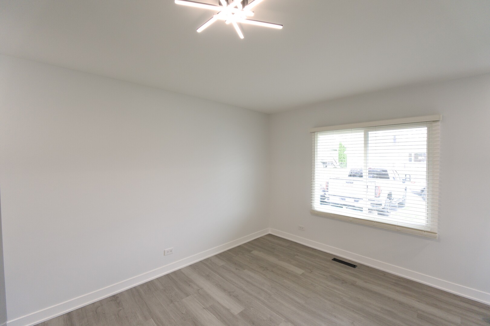 1406 Ridgeway Street Round Lake Beach, IL 60073 - Photo 12 of 33 an empty room with wooden floor and windows