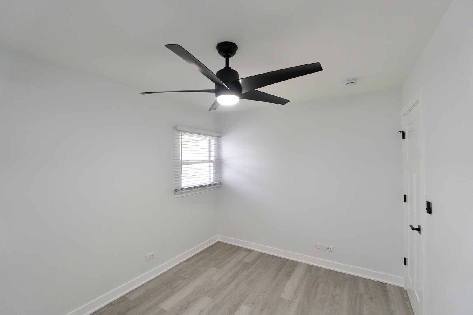 1406 Ridgeway Street Round Lake Beach, IL 60073 - Photo 19 of 33 an empty room with a window and a fan