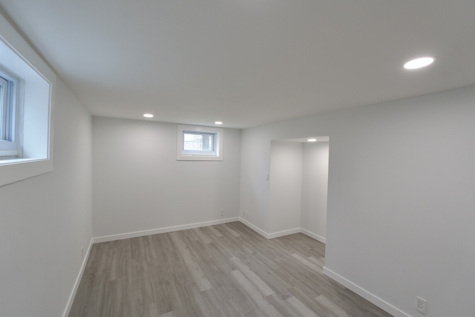 1406 Ridgeway Street Round Lake Beach, IL 60073 - Photo 25 of 33 an empty room with wooden floor and windows