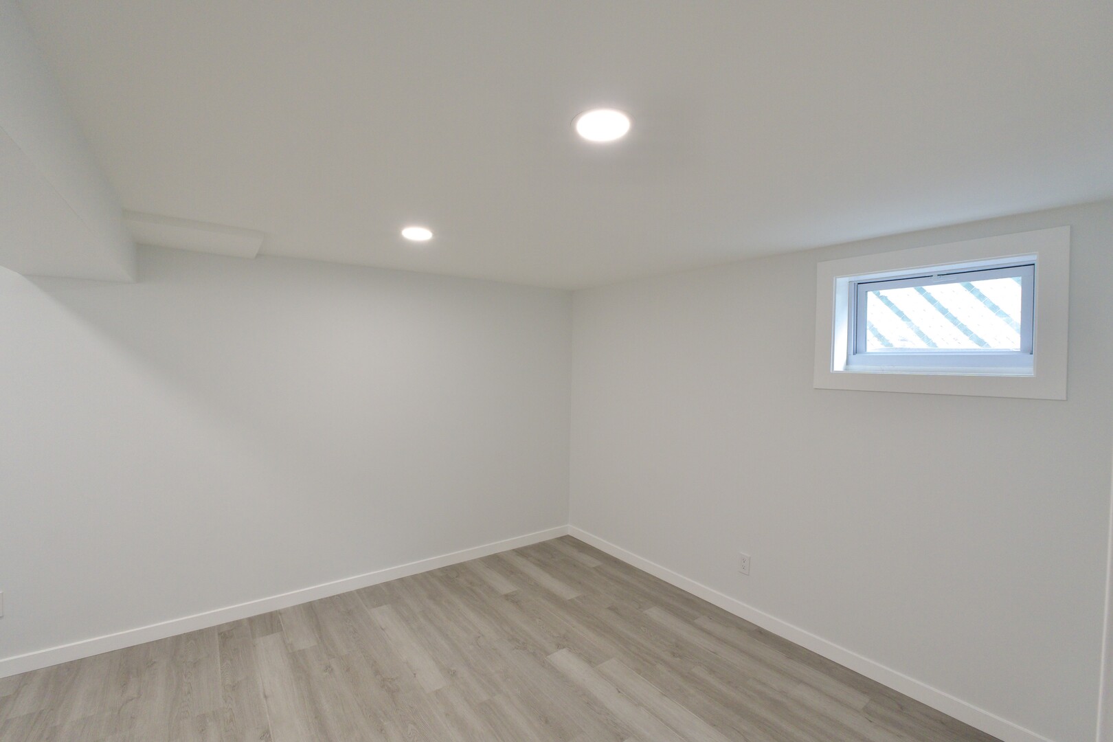 1406 Ridgeway Street Round Lake Beach, IL 60073 - Photo 27 of 33 a view of an empty room with wooden floor and a window