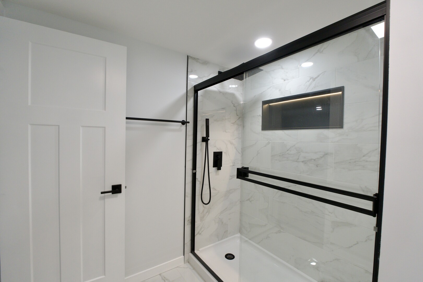 1406 Ridgeway Street Round Lake Beach, IL 60073 - Photo 29 of 33 a bathroom with a shower and a glass door