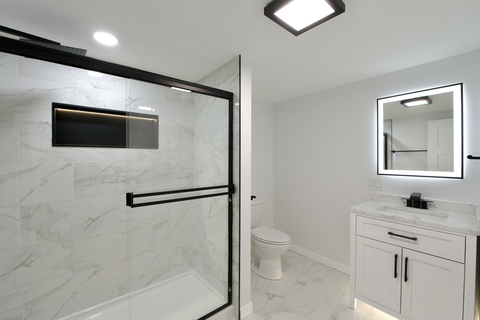 1406 Ridgeway Street Round Lake Beach, IL 60073 - Photo 30 of 33 a bathroom with a toilet sink and mirror