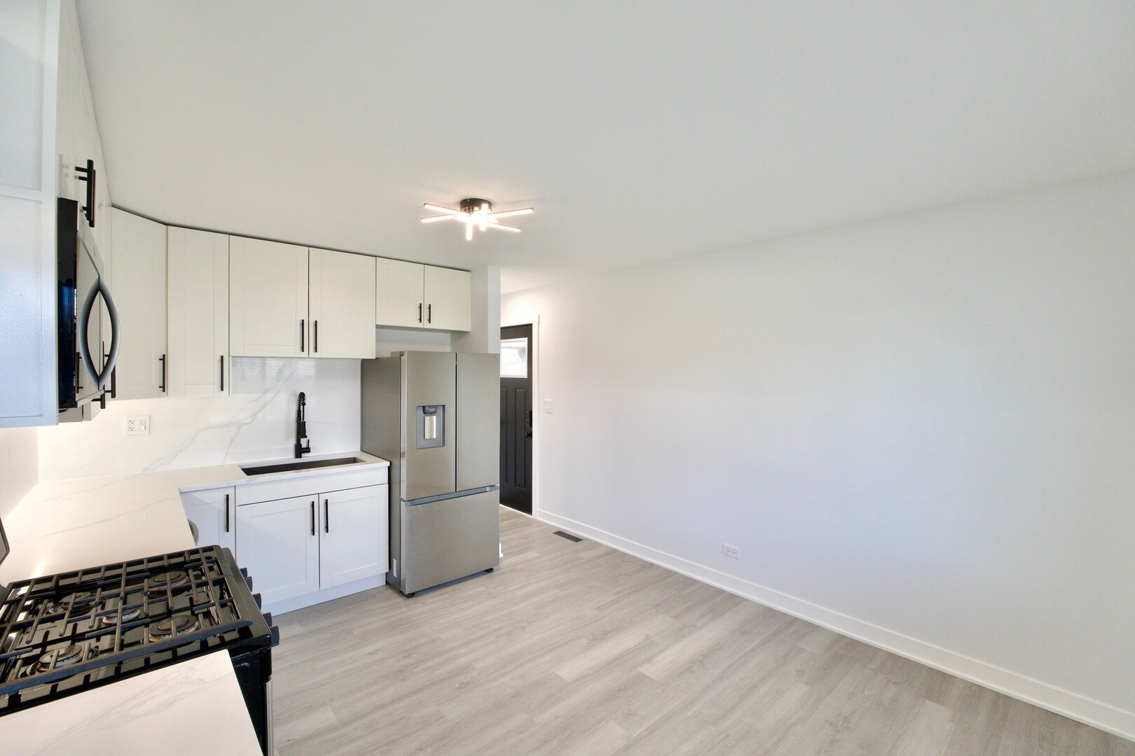 1406 Ridgeway Street Round Lake Beach, IL 60073 - Photo 9 of 33 a kitchen with a sink appliances and cabinets