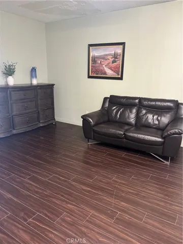 a view of a living room with wooden floor