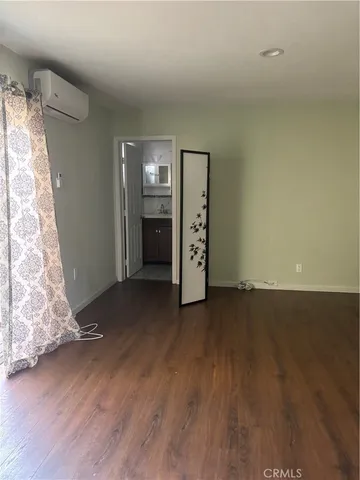 an empty room with wooden floor and closet