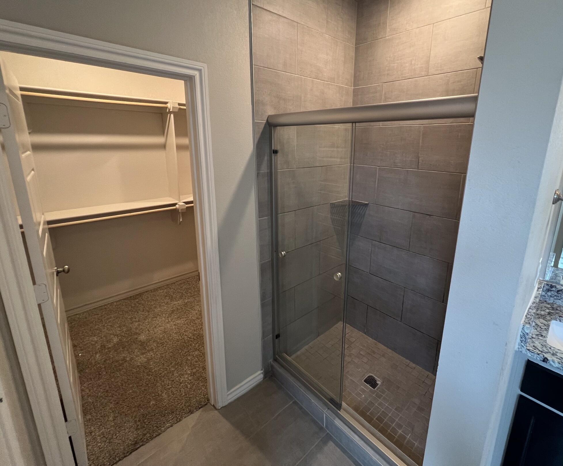 816 North 3rd Street Wolfforth, TX 79382 - Photo 12 of 28 a bathroom with a glass shower door