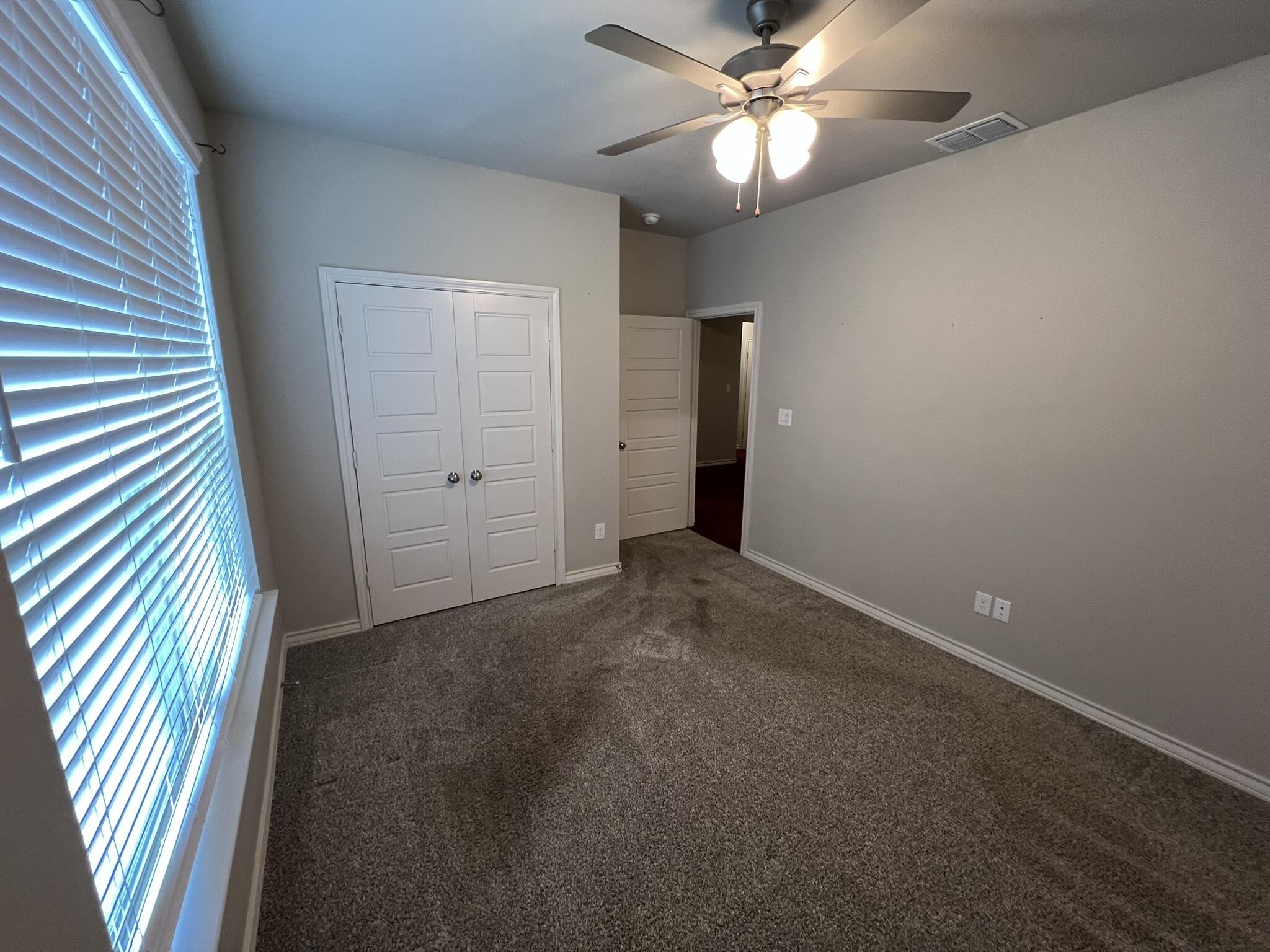 816 North 3rd Street Wolfforth, TX 79382 - Photo 15 of 28 en empty room with windows and fan