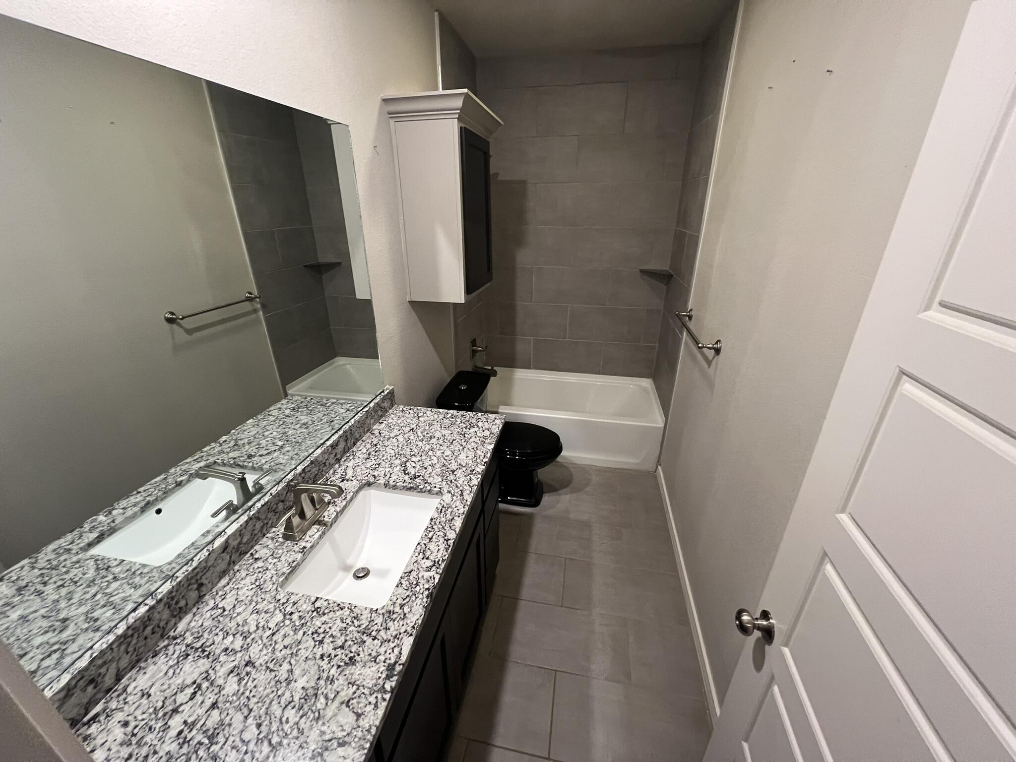 816 North 3rd Street Wolfforth, TX 79382 - Photo 17 of 28 a bedroom with a bed and wooden floor