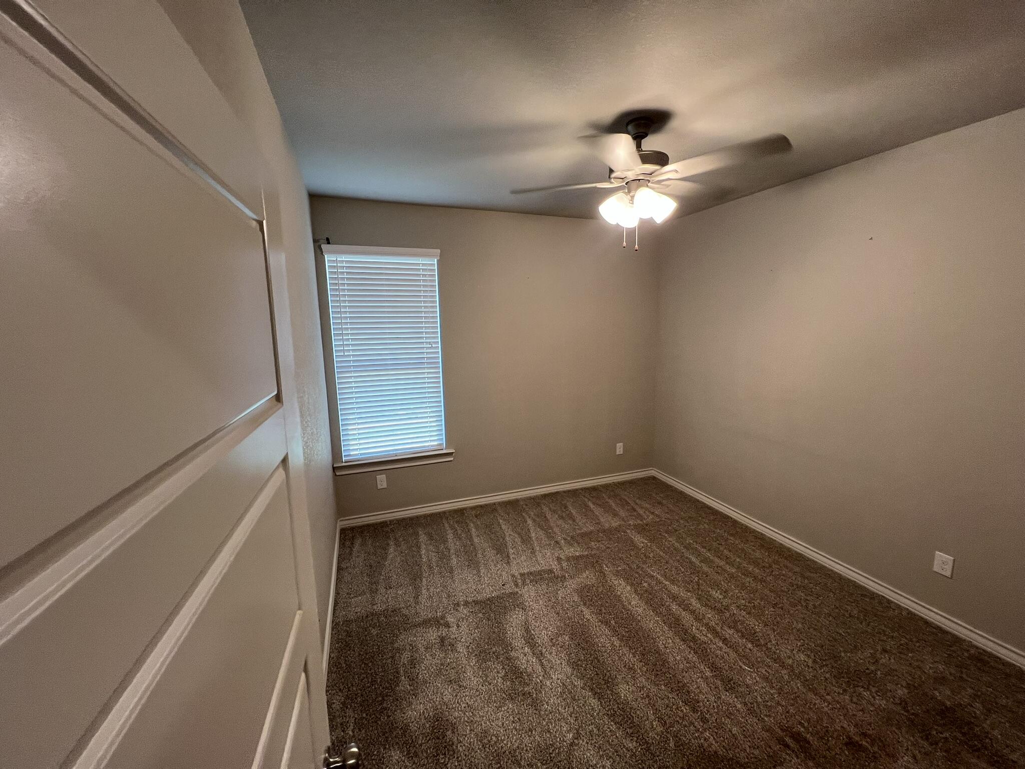 816 North 3rd Street Wolfforth, TX 79382 - Photo 21 of 28 a view of empty room with wooden floor and fan