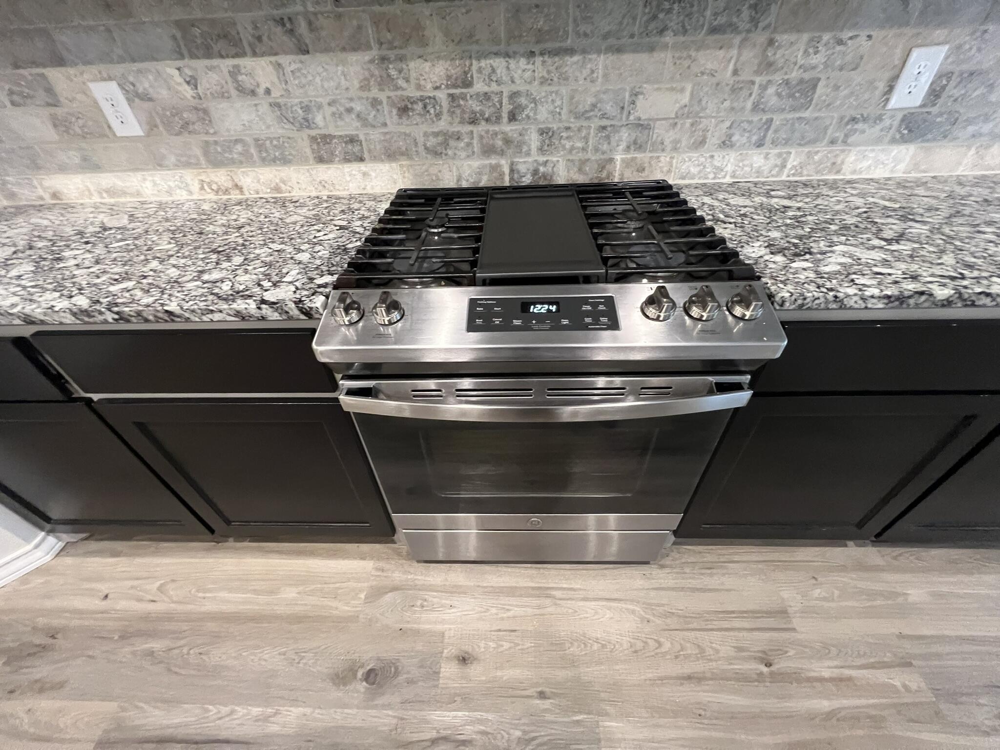 816 North 3rd Street Wolfforth, TX 79382 - Photo 7 of 28 a stove top oven sitting inside of a kitchen