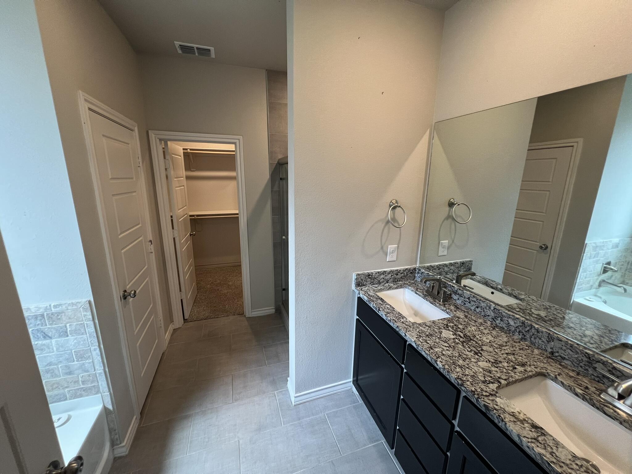 816 North 3rd Street Wolfforth, TX 79382 - Photo 10 of 28 a bathroom with a granite countertop sink and a mirror