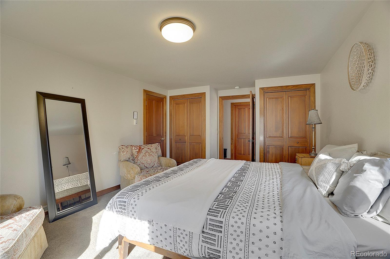 468 Riverside Drive Lyons, CO 80540 - Photo 30 of 50 a bedroom with a bed and a large mirror