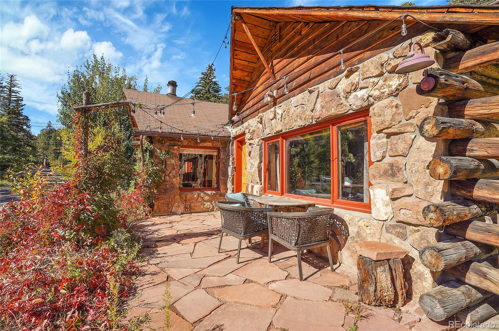 468 Riverside Drive Lyons, CO 80540 - Photo 31 of 50 a view of a patio with table and chairs and potted plants