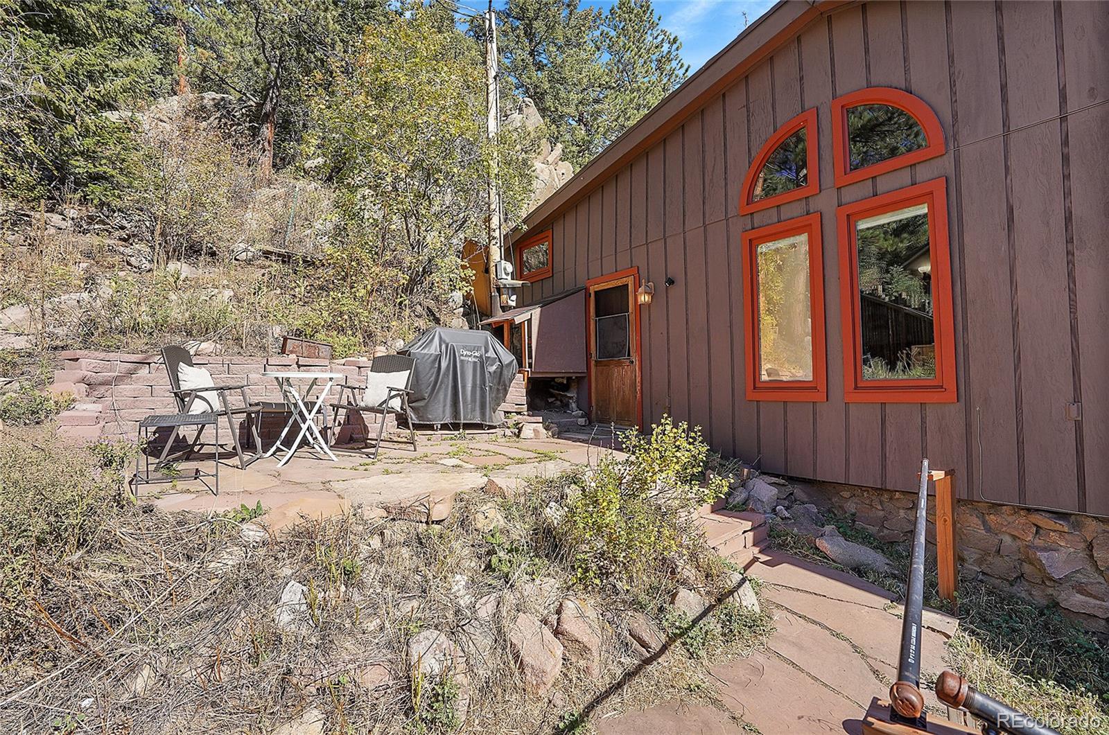 468 Riverside Drive Lyons, CO 80540 - Photo 47 of 50 a backyard of a house with table and chairs
