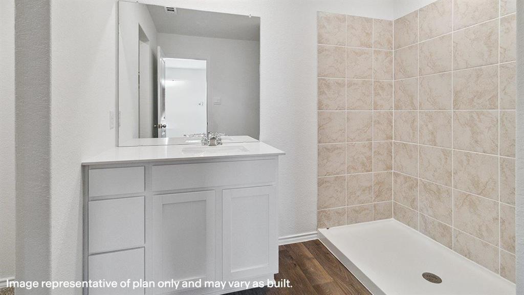 3331 Twilight Trail Forney, TX 75126 - Photo 21 of 31 Bathroom featuring a white vanity with integrated sink, chrome faucet, and expansive mirror