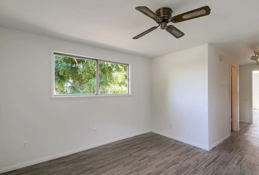 4276 Orchard Drive Spring Valley, CA 91977 - Photo 18 of 19 an empty room with wooden floor fan and windows