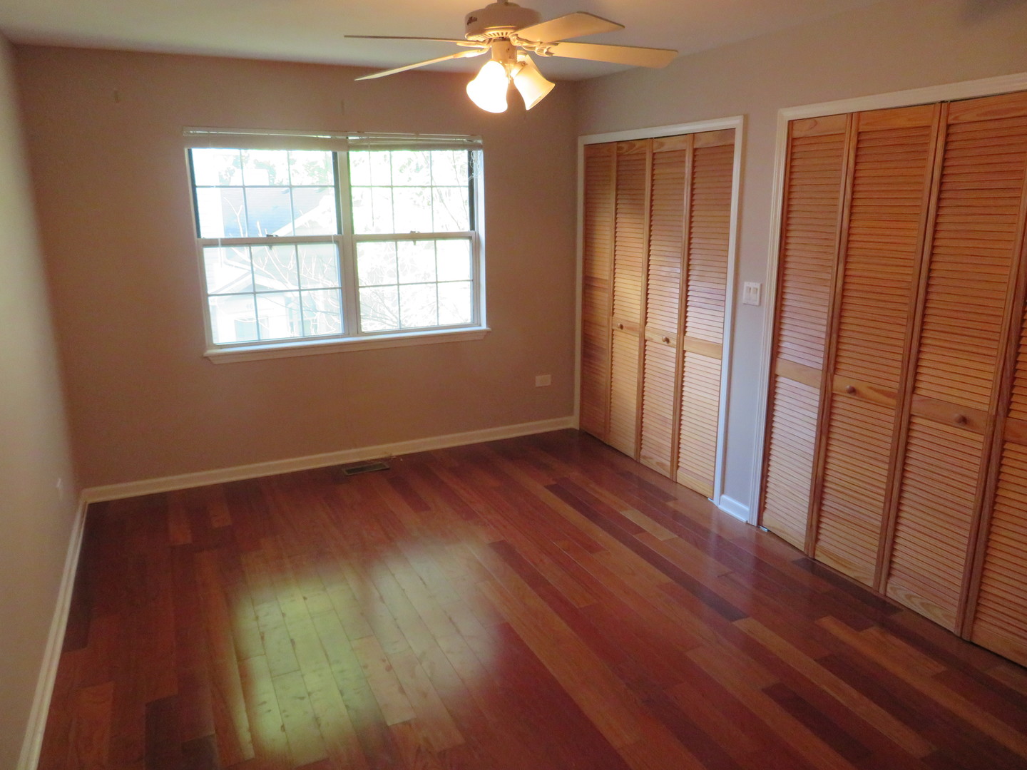 457 North Cambridge Drive, Unit 457 Palatine, IL 60067 - Photo 15 of 31 a view of empty room with wooden floor and fan