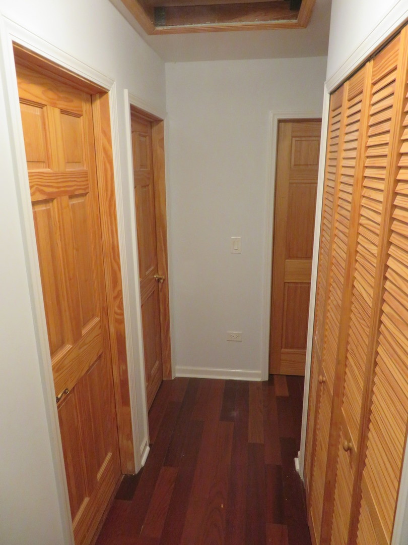 457 North Cambridge Drive, Unit 457 Palatine, IL 60067 - Photo 19 of 31 an empty room with wooden floor and a window